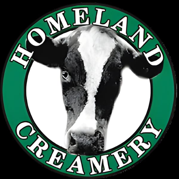 Homeland Creamery logo featuring a black and white cow's head inside a green circle with text.